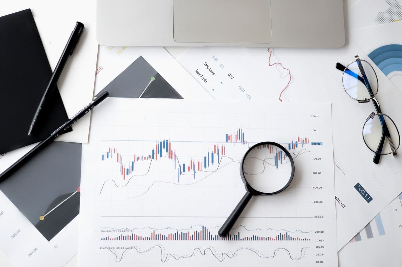 Financial analyst reviewing market charts and reports