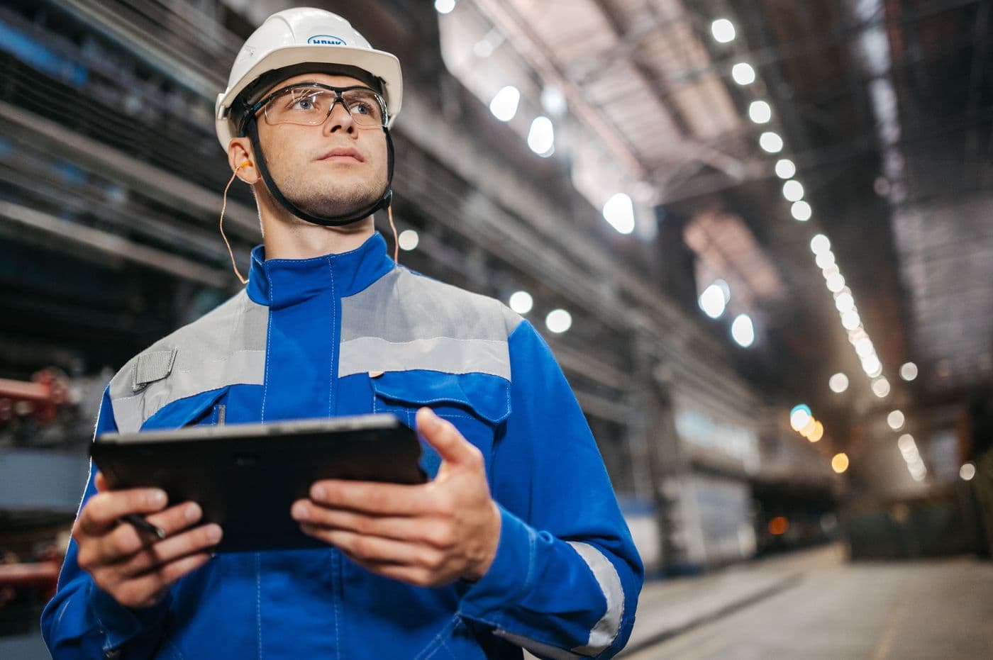 Industrial operator reviewing live production data on a tablet